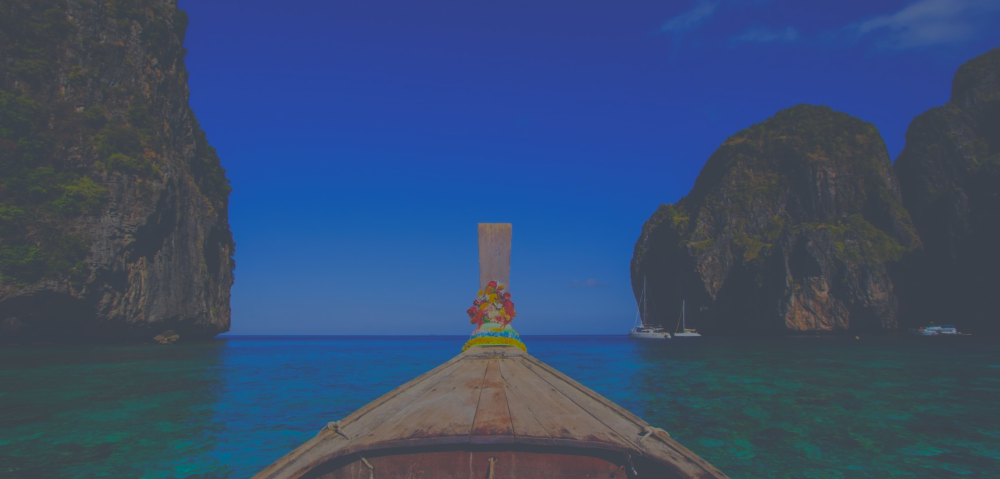 A boat sailing out of the grotto back into the open seas. 